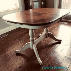 a white and wood table in front of a window