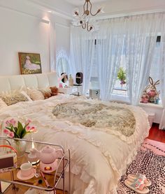 a white bed sitting in a bedroom next to a window