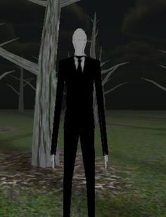 a man in a suit and tie standing next to a tree