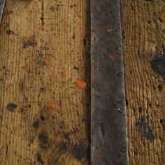 an old pair of scissors sitting on top of a wooden table