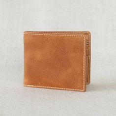 Our Bi-fold Wallet is a best-selling favorite for its classic design and durable, full-grain leather construction. It will only get better with time as the natural oils from his hands add unique character and a beautiful patina finish. Thanks to the strong fibers of full-grain leather, he'll be enjoying this timeless style for years to come. Classic Trifold Wallet In Cognac For Everyday Use, Classic Cognac Trifold Wallet For Everyday Use, Brown Rectangular Wallet With Waxed Finish, Vintage Brown Bifold Wallet With Coin Pocket, Vintage Brown Bifold Wallet For Daily Use, Classic Leather Wallet, Vegetable-tanned, Brown Rectangular Trifold Wallet With Waxed Finish, Brown Trifold Wallet With Coin Pocket For Everyday, Vintage Brown Bifold Wallets With Card Slots