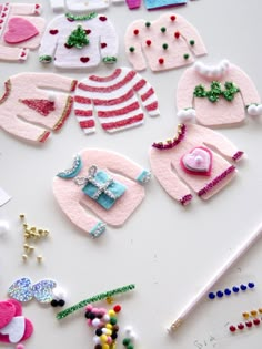 several pieces of clothing and accessories are laid out on a white surface with beading