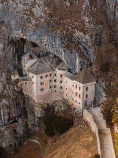 an old castle built into the side of a mountain