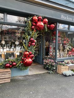 a store front decorated with christmas decorations and wreaths