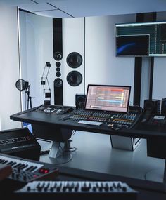 a recording studio with multiple monitors and sound equipment