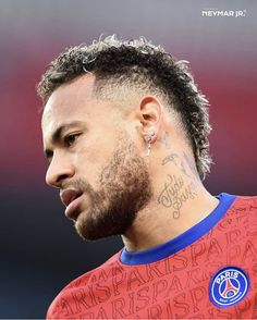 a close up of a soccer player with tattoos on his face and neck, looking off to the side