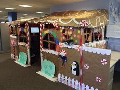 an office cubicle decorated with gingerbread houses and candy canes on the walls