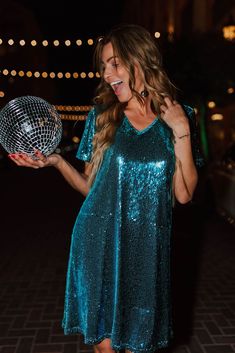 Get ready to sparkle in THE SEQUIN SHIFT DRESS IN AQUA. With its shimmering blue sequins and flattering shift cut, this is the perfect party dress for any occasion, especially New Year's Eve. Add some fun and glam to your wardrobe with this must-have dress! Aqua blue colored sequin V-neck Short sleeve Mini length Hidden side pockets Fully lined Zip up back 95% polyester, 5% spandex Pink Desert Brand Runs true to size. X-Small (00-2), Small (2-4), Medium (6-8), Large (8-12), X-Large (12-14), XX-L Sequin Shift Dress, Pink Desert, Perfect Party, New Year's, Aqua Blue, Shift Dress, Must Haves, Zip Ups, Party Dress