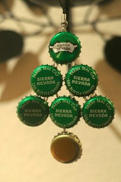 several green bottle caps hanging from a black cord