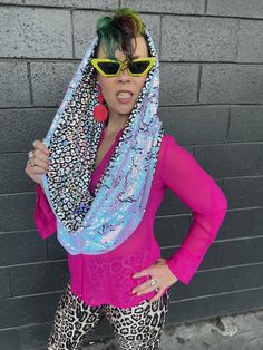 GLAM Infinity Scarf is designed to shield you from the sun, wear as a top and look fabulous all in one. Can be worn slightly back on the head by fastening a bobby pin to the tag provided inside the hood.  Unicorn Dreams Reversible GLAM Infinity Scarf (iridescent pink to blue Sequins) & holographic leopard lining ~Reversible and Handmade ~ holographic iridescent, blue pink reversible Sequins ~ holographic leopard 4 way stretch spandex lining   Feel stunning in this eye catching sequin sparkle infinity scarf. It's Perfect addition to glam up any festival or party style. Processing time can be up to 1-2 weeks or as early as a few days.  NEED A RUSH ORDER? Totally Possible. Rush fee of $5.00- $10.00 may apply. I'll do my best to get it out for you asap. Please DM me with any special requests o Holographic Iridescent, Iridescent Blue, Hooded Scarf, Scarf Top, Bobby Pin, Party Fashion, Festival Wear, Infinity Scarf, Bobby Pins