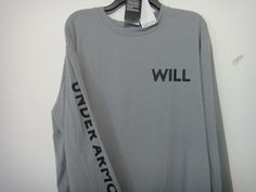 a gray long sleeved shirt with black writing on it