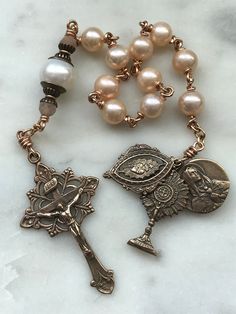 This is a beautiful, wire-wrapped, heirloom single decade rosary! The rosary is handmade with 20 gauge bronze wire. The medals and crucifix are all bronze. The beads are 7 and 9mm freshwater pearls with faceted sunstones. The Rosary is the most excellent form of prayer and the most efficacious means of attaining eternal life. It is the remedy for all our evils, the root of all our blessings. There is no more excellent way of praying.~Pope Leo XIII Adjustable Rose Gold Spiritual Rosary, Spiritual Wire Wrapped Rosary As Gift, Spiritual Gift Wire Wrapped Rosary, Faith Of Our Fathers, Pope Leo Xiii, Pope Leo, Bijoux Art Nouveau, Decade Rosary, Bird Beads