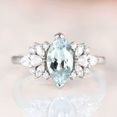 an oval aquamarinee and white diamond ring