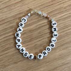 a white beaded bracelet with words on it that say change is porridger