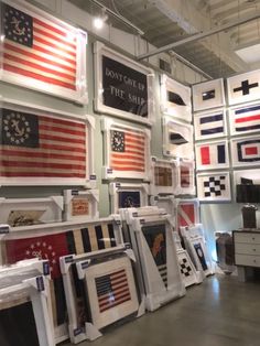 a room filled with lots of framed american flags