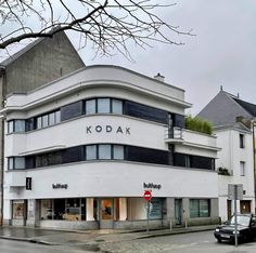 the kodak building is white and has windows on each level that are open to let in light