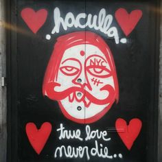 graffiti on the side of a door that says noulia, true love never dies