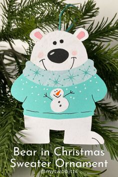 a polar bear ornament hanging from a christmas tree with snowman on it