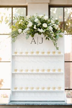 a display case with flowers and candles on the front for guests to sit down at