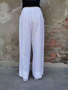 "White Linen Pants, Wide Leg Linen Pants, ✥ Welcome to my world! I create my design in my dreams and I draw geometric lines and extravagant patterns with scissors, needles and thread. Be my dream catcher and let me create for you a parallel fashion world! ✥ SHIPPING Express shipping: 2-3 biz days via DHL Worldwide ✥ SIZING The model in the picture wears size M. Height: 5'9\" and weigh 60 kg. Available sizes: XS - 3XL Please, refer to my Size Chart below to find your perfect size match! Keep in m White Plain Bottoms For Summer, Plain White Summer Bottoms, White Linen Ankle-length Bottoms, White Harem Pants With Pockets For Loungewear, Plain Summer Trousers, White Linen Straight Pants, White Straight Leg Harem Pants With Pockets, Casual White Plain Pants, White Harem Pants For Loungewear