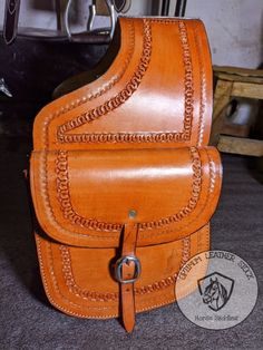 an orange leather bag sitting on top of a table