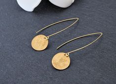 These earrings feature textured brass round charm hanging from a gold plated drop wire. These modern earrings are light weight. The disc is 1/2" diameter. The drop length is 1". These earrings come with a rubber stopper. All items used are lead free, cadmium free and nickel safe. Earrings ship out immediately. All purchases come packaged in a gift box ready for gifting. Please do not hesitate to contact me if you have any questions. Please Note: Due to monitor and lighting differences, the actual product's colors may vary slightly from what appears online. CARE Store these earrings in a clean, dry place. Use of oils, creams or perfumes can cause the metals to tarnish quickly. RETURNS If you are not satisfied with the purchase please contact me within 7 days of delivery, and return your pur Gold Round Threader Earrings For Everyday, Gold Minimalist Round Pendant Earrings, Gold Coin Earrings, Gold Disc Earrings, Earrings Circle, Coin Earrings, Gold Disc, Earrings Round, Disc Earrings