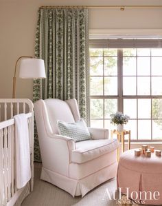 a baby's room with a crib, rocking chair and window in it