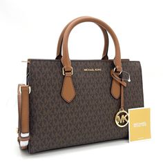 Brand New With Tag Michael Kors Sheila Medium Center Zip Satchel Bag Details Color: Brown Satchel Faux Leather 88.92% Coated Canvas/11.08% Polyester Gold-Tone Hardware 11”W X 8”H X 3.25”D Handle Drop: 4” Interior Details: Back Zip Pocket, 2 Front Slip Pockets Lining: 100% Polyester Zip Fastening Imported Luxury Michael Kors Satchel With Leather Handles, Handbags Outfits, Michael Kors Satchel With Gold-tone Hardware, High End Handbags, Luxury Michael Kors Bags With Gold-tone Hardware, Michael Kors Bags With Gold-tone Hardware For On-the-go, Brown Satchel, Michael Kors Bags With Gold-tone Hardware, Michael Kors Brown Bags With Gold-tone Hardware