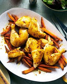 a white plate topped with chicken and carrots