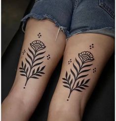 two women with matching tattoos on their legs