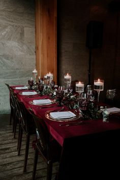 the table is set with place settings and candles for dinner guests to sit down at