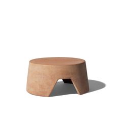 a small wooden stool sitting on top of a white floor