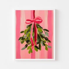 a pink painting with green leaves and a red ribbon hanging from it's center