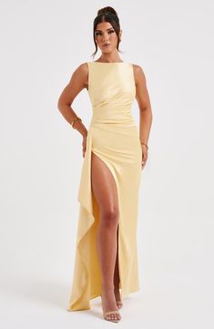 More-is-more with the Peggy maxi, a flirty dress made in sleek, body-hugging satin with stretch. With a high, wide neckline and low scoop back, this maxi has a draped thigh high split and removable corsage to the shoulder with frill detailing. Wear yours with loose waves and metallic heels. 



Colour: Lemon.

Luxury stretch satin.

Fully lined.

Body hugging fit.

High, wide neckline.

Low scoop back.

Asymmetric pleats to waist.

Removable corsage with frill details.

Draped thigh high split. Long Skirt Elegant, Party Dress Club, Backless Satin Dress, Skirt Elegant, Strap Dresses, Long Bodycon Dress, Flirty Dresses, Bodycon Maxi Dresses, Elegant Skirt