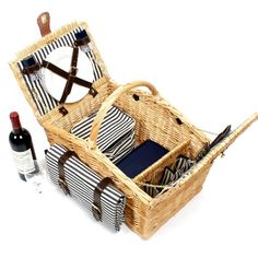 a wicker picnic basket with wine bottle and napkins in it, on a white background