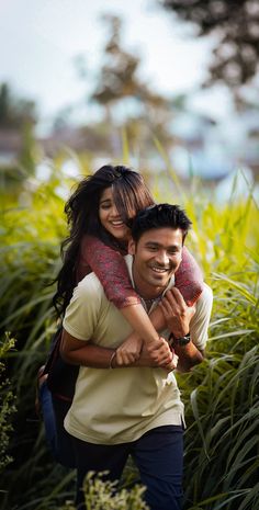 a man carrying a woman on his back in front of tall grass and plants with the caption endraga international