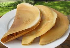 three pieces of food on a white plate