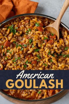 an american goulash in a skillet with a wooden spoon on the side