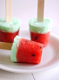 watermelon popsicles on a white plate with toothpicks