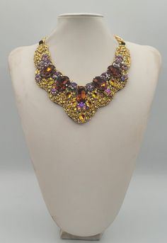 Each piece of our statement necklaces is handmade and one of a kind made in Italy. Our creations is made of high quality materials such as crystals and rhinestones. Each embroidered material is carefully hand sewn. Very glamorous and stylish. Perfect gift to someone you like. Materials Strass stone and Rhinestone in Rainbow, Cooper and Brown color in different dimension.  Black satin fabric backing. Aluminium chain with lobster closure. Measurements Weight approximate 200 grams. Chain lenght 25 cm - 9.84 in Circumference approximate 63 cm - 24.80 in Feel free to contact us if you have any question. Thank you so much for looking at our shop and our articles each of them, single piece. Costume Jewelry Necklace With Sparkling Stones For Party, Luxury Choker Necklace For Party, Luxury Party Choker Necklace, Luxury Rhinestone Necklaces For Parties, Costume Jewelry Necklaces With Sparkling Stones For Evening, Evening Costume Jewelry Necklaces With Sparkling Stones, Luxury Evening Necklaces With Stones, Luxury Stone Necklaces For Evening, Handmade Glamorous Jewelry Gift