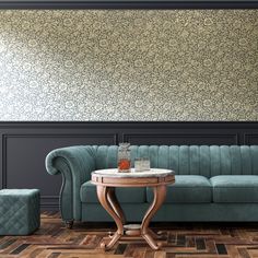 a blue couch sitting next to a table on top of a hard wood floor