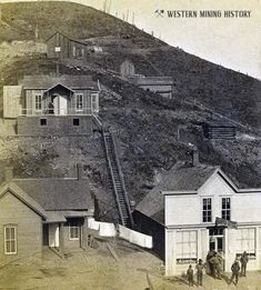 an old black and white photo of people standing in front of a mountain side house