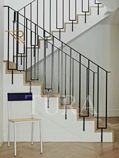 a white chair sitting in front of a stair case