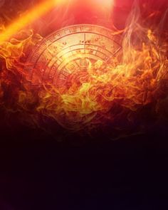 fire and flames surrounding a clock on a black background with bright light coming from the top