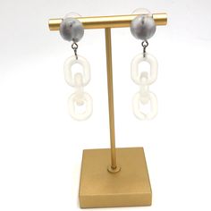 Moonglow button studs meet frosted lucite chain in these retro meets modern statement earrings. Each earring measures just under 2.25" or 58mm in length & are super light weight. Earrings are made with mostly vintage lucite parts that were made in the US in the 1960's - early 80's. We hand-set them with surgical steel earring posts and they have sturdy surgical steel/acrylic backings on them as well. White Plastic Earrings For Parties, Modern White Lucite Jewelry, Trendy White Metal Clip-on Earrings, Trendy White Drop Clip-on Earrings, Trendy White Plastic Earrings, Modern White Resin Earrings, Trendy White Earrings, Button Studs, Silver Statement Earrings