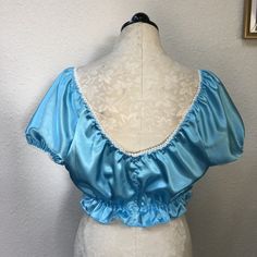 Satin babydoll style top with ruffled trim. Fitted Tops With Ruffled Straps And Details, Fitted Tops With Ruffled Straps, Blue Ruffled Straps Top, Coquette Ruffled Tops For Spring, Spring Coquette Tops With Ruffles, Blue Fitted Top With Ruffled Collar, Vintage Blue Ruffled Blouse, Satin Babydoll, Womens Blouses