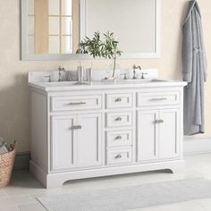 a white bathroom vanity with two sinks and mirrors