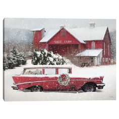 an old red car is parked in front of a barn with wreaths on it