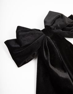 a black bow tie laying on top of a white table