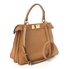 This is an authentic FENDI Vitello Seta Shiny Nappa Medium Peekaboo I SEE U Satchel in Miele Scuro and Light Rose. This chic tote is finely crafted of light brown calfskin leather. This medium-sized bag features gold squared turn locks on either side that when released, relax the outer layer to reveal a chenille inner panel, a matching top handle, an optional shoulder strap, and gold hardware. This opens to a partitioned pink leather interior with a removable pouch. Pokemon Fabric, Fendi Peekaboo Bag, Fendi Shoulder Bag, Fendi Peekaboo, Medium Sized Bags, Python Print, Light Rose, Rose Lights, Fendi Bags